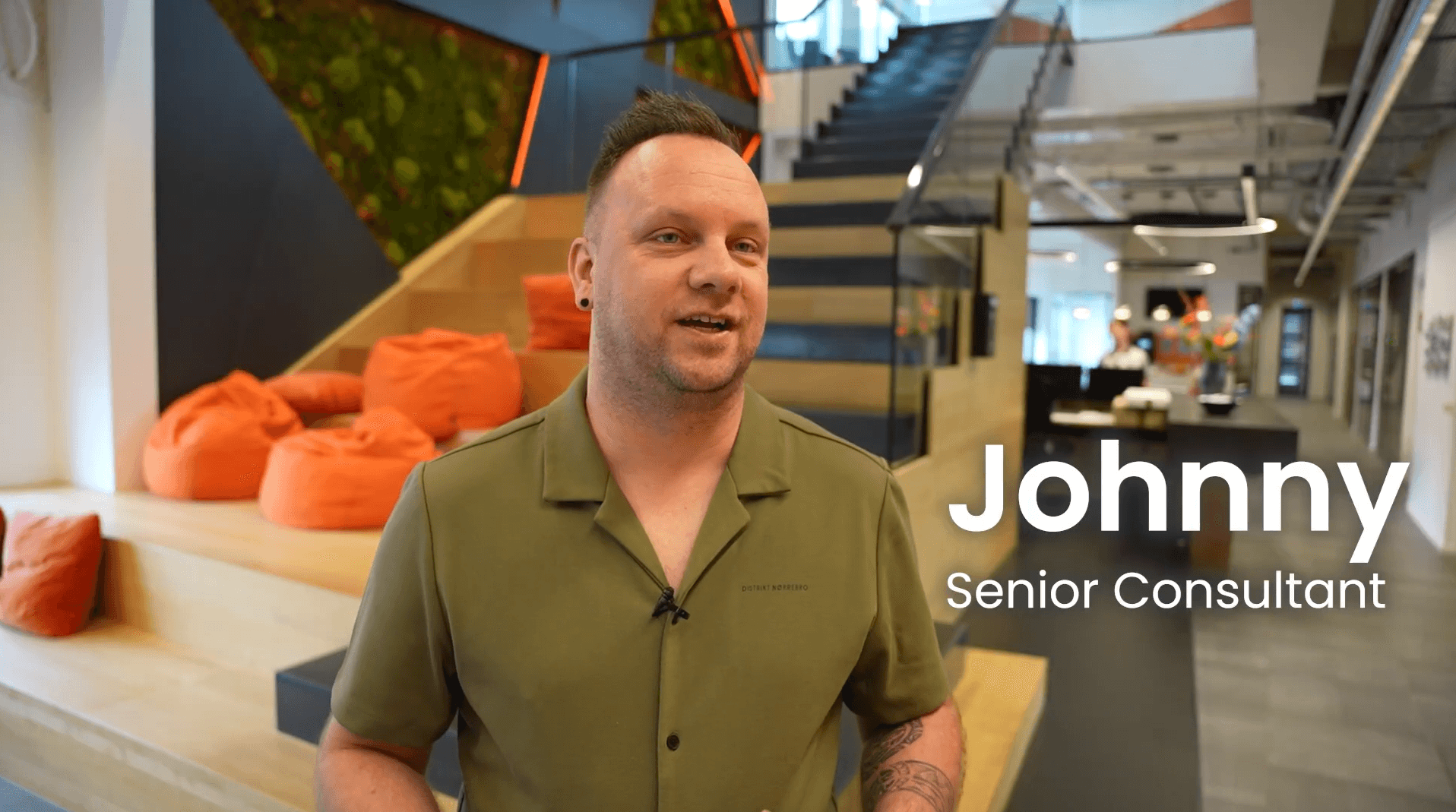 Innovative workplace environment at Keylane with Senior Consultant Johnny sharing insights about career growth and company culture in a modern, vibrant office setting.