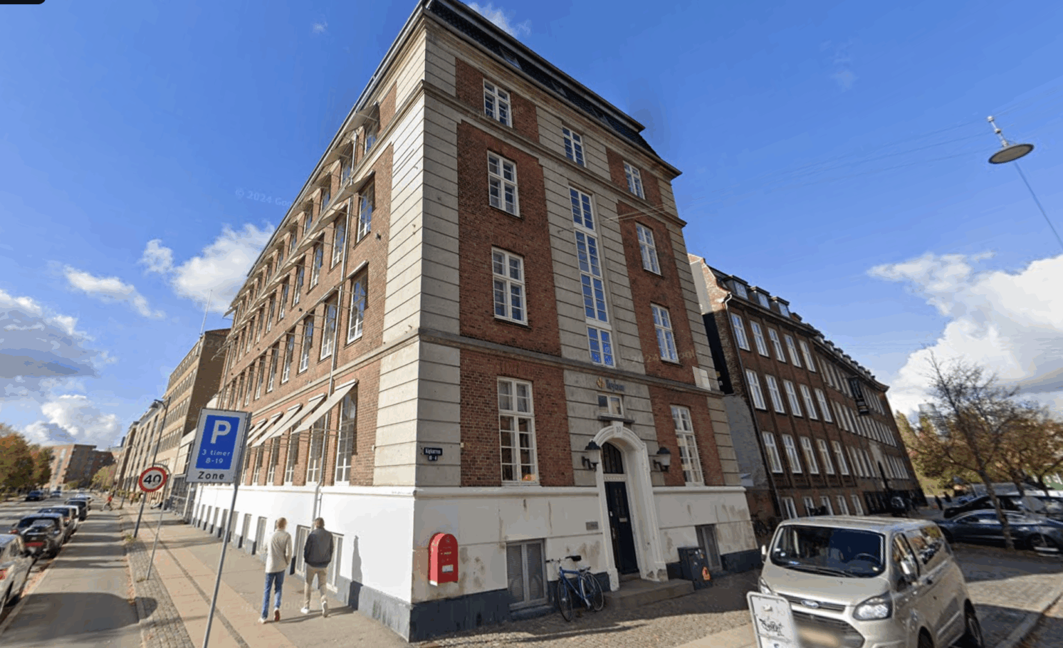 Modern brick office building hosted Keylane's career center, showcasing an inviting workspace with accessible parking and pedestrian pathways, ideal for tech and finance industry professionals.