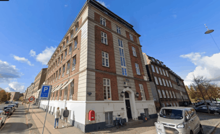 Modern brick office building hosted Keylane's career center, showcasing an inviting workspace with accessible parking and pedestrian pathways, ideal for tech and finance industry professionals.