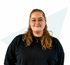 Innovative woman smiling in casual black attire, representing diverse careers at Keylane, a leading healthcare and insurance technology company, focused on dynamic career opportunities and company culture.