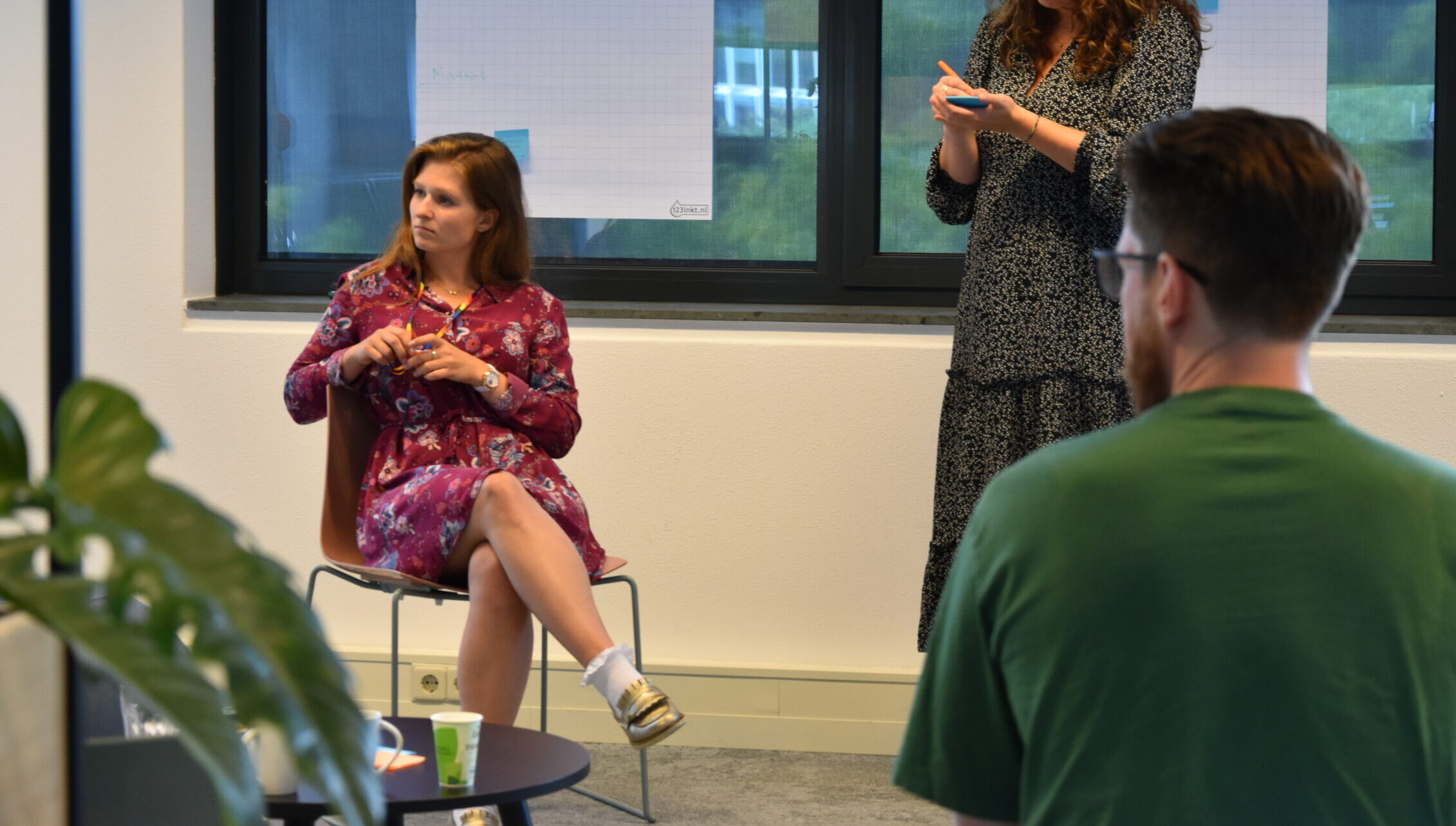 1. Diverse team participating in a Keylane Careers workshop, collaboration and innovation in a professional office environment with colorful sticky notes on whiteboards.