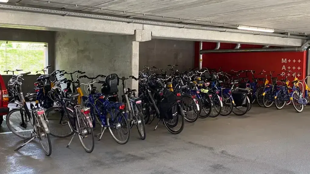 Bike parking area at Keylane Careers office, featuring numerous bicycles in an underground parking garage, emphasizing eco-friendly transportation and employee commuting options.