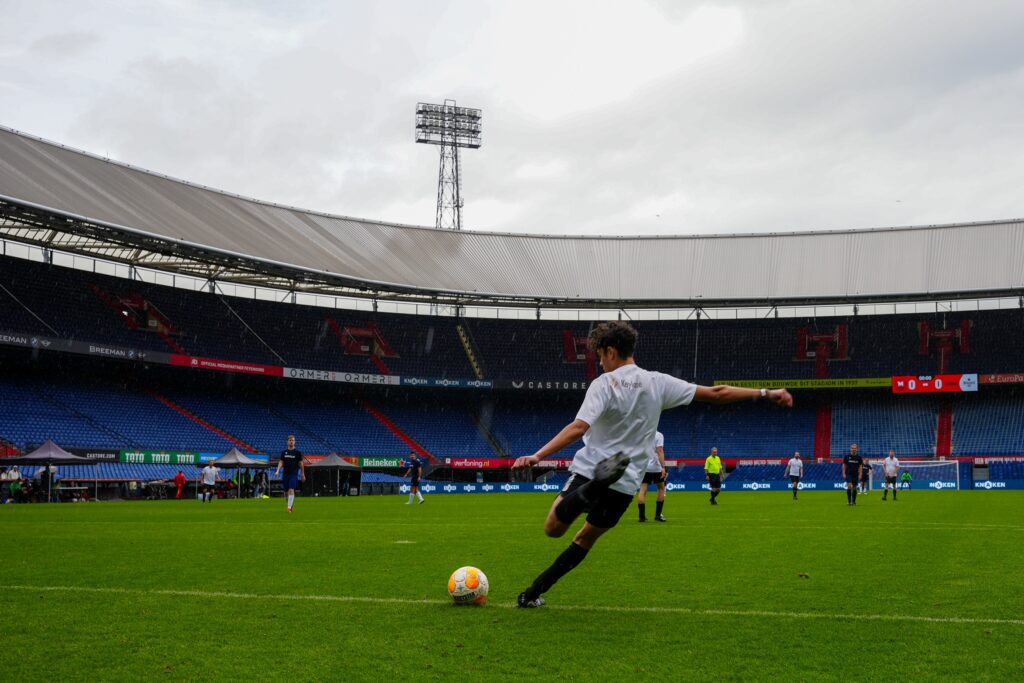 A Keylane player kicks the ball long during the corporate football tournament at De Kuip