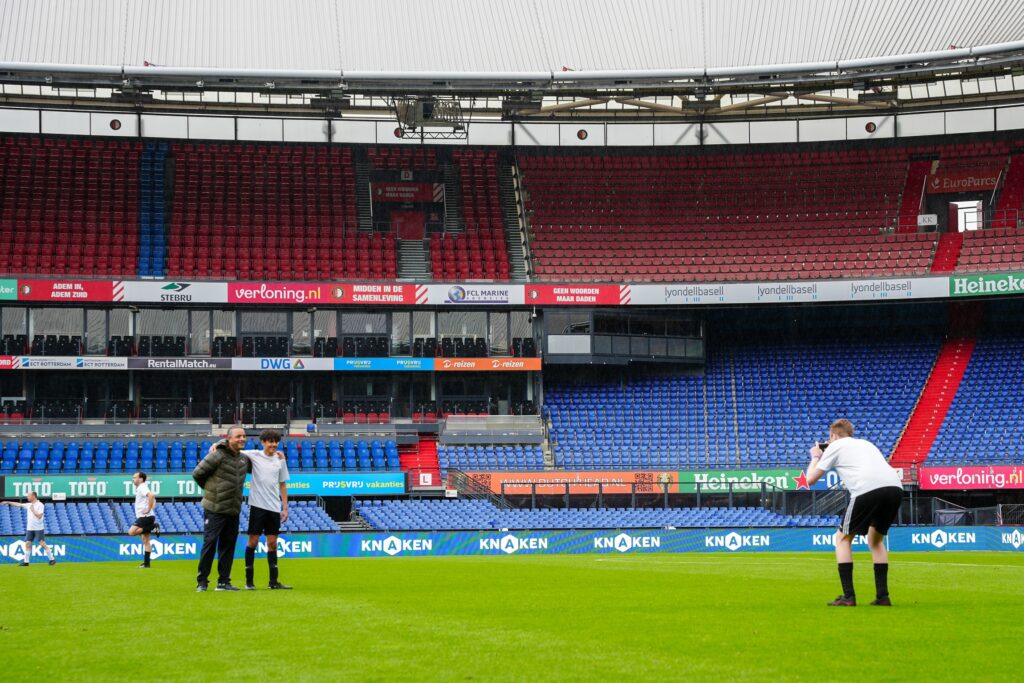 Keylane colleagues taking photos on the pitch at De Kuip during a break between matches